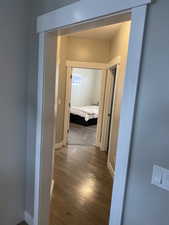 Hallway with hardwood / wood-style flooring
