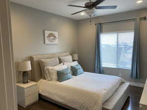 Bedroom featuring dark hardwood / wood-style flooring and ceiling fan