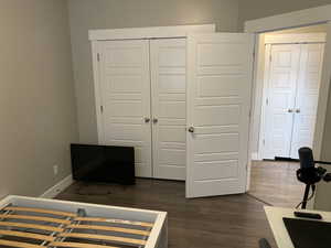 Unfurnished bedroom with a closet and dark hardwood / wood-style floors