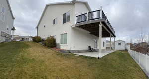 Rear view of house featuring a yard and a patio area