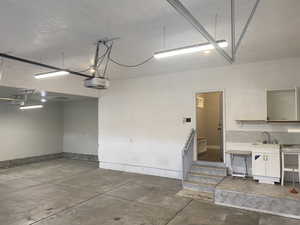 Garage with sink and a garage door opener