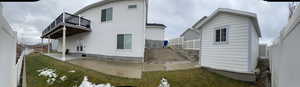 Back of house with a yard, a patio area, and a balcony
