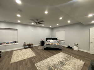 Bedroom featuring ceiling fan and dark wood-type flooring