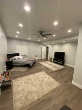 Bedroom featuring ceiling fan and dark hardwood / wood-style flooring
