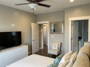 Bedroom featuring ceiling fan and dark wood-type flooring