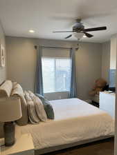 Bedroom with ceiling fan and hardwood / wood-style flooring