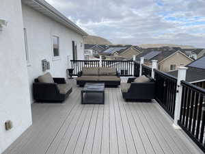 Wooden deck with a mountain view and an outdoor hangout area