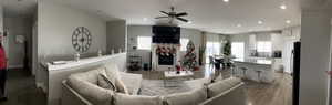 Living room with hardwood / wood-style flooring and ceiling fan