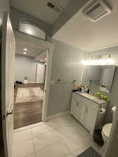 Bathroom featuring tile patterned flooring, vanity, and toilet