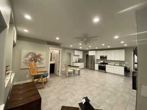 Kitchen featuring white cabinets, appliances with stainless steel finishes, and ceiling fan