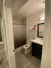Bathroom featuring walk in shower, tile patterned floors, a textured ceiling, toilet, and vanity