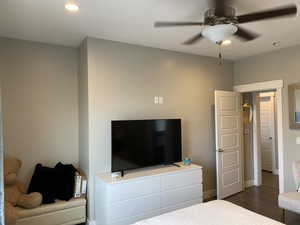 Bedroom featuring ceiling fan and dark wood-type flooring