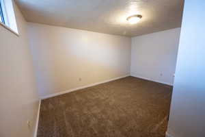 Carpeted bedroom featuring a textured ceiling