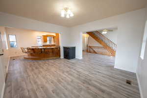 Interior space with ceiling fan and wood-type flooring