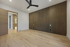 Spare room with ceiling fan and light wood-type flooring