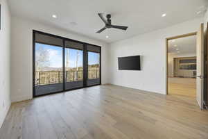 Spare room with ceiling fan and light wood-type flooring