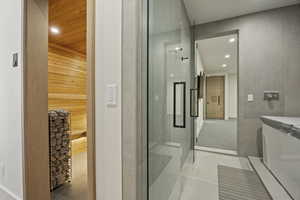 Bathroom with tile patterned flooring and wooden walls