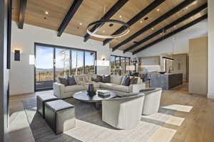 Living room with sink, high vaulted ceiling, wood ceiling, and light wood-type flooring