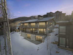 Snow covered house featuring a balcony