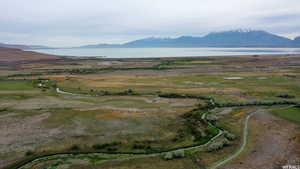 Property view of mountains with a rural view and a water view