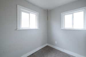 Spare room with plenty of natural light and carpet floors