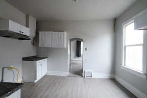 Kitchen featuring white cabinetry and light lvp flooring