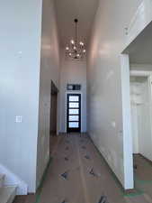 Foyer featuring a towering ceiling and a notable chandelier