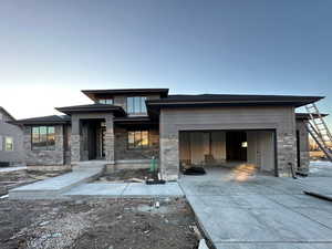 Prairie-style home featuring a garage