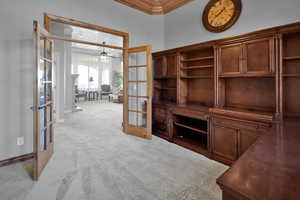 Office featuring ceiling fan, crown molding, light carpet, and french doors