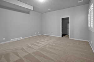 Unfurnished room featuring light carpet