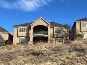 Back of house with a balcony