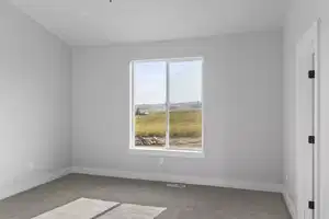 Empty room featuring light colored carpet