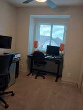 Office featuring light colored carpet and ceiling fan