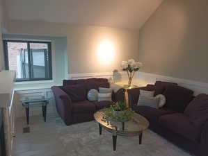 Living room featuring hardwood / wood-style floors and vaulted ceiling