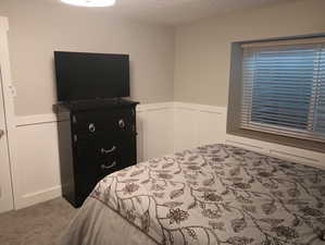 Carpeted bedroom featuring a textured ceiling