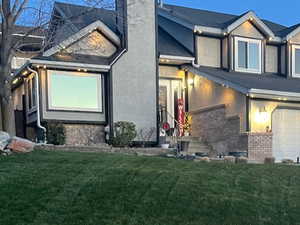 View of side of home featuring a lawn and a garage