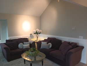 Living room featuring lofted ceiling