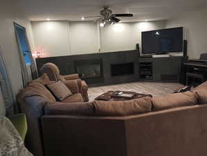 Living room featuring hardwood / wood-style floors and ceiling fan