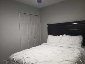 Bedroom featuring ceiling fan and a closet