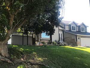 Exterior space with a garage and a front lawn