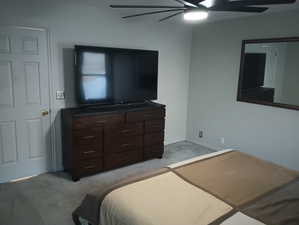 Carpeted bedroom with ceiling fan