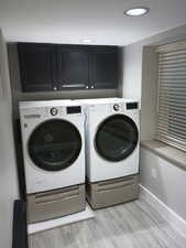 Laundry room with cabinets and washing machine and clothes dryer