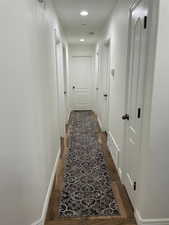 Hallway with dark hardwood / wood-style floors