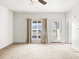 Spare room with ceiling fan and light carpet