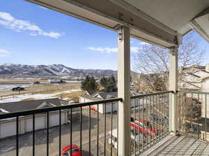 Snow covered back of property featuring a mountain view