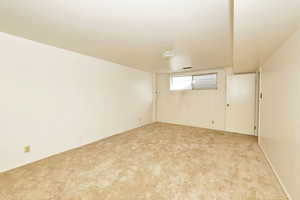 Basement with light carpet