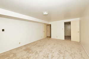 Unfurnished room featuring light colored carpet