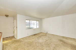 Spare room with light colored carpet