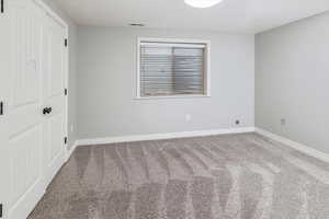 Unfurnished bedroom featuring carpet flooring and a closet