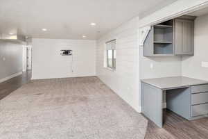 Interior space featuring hardwood / wood-style floors and wood walls